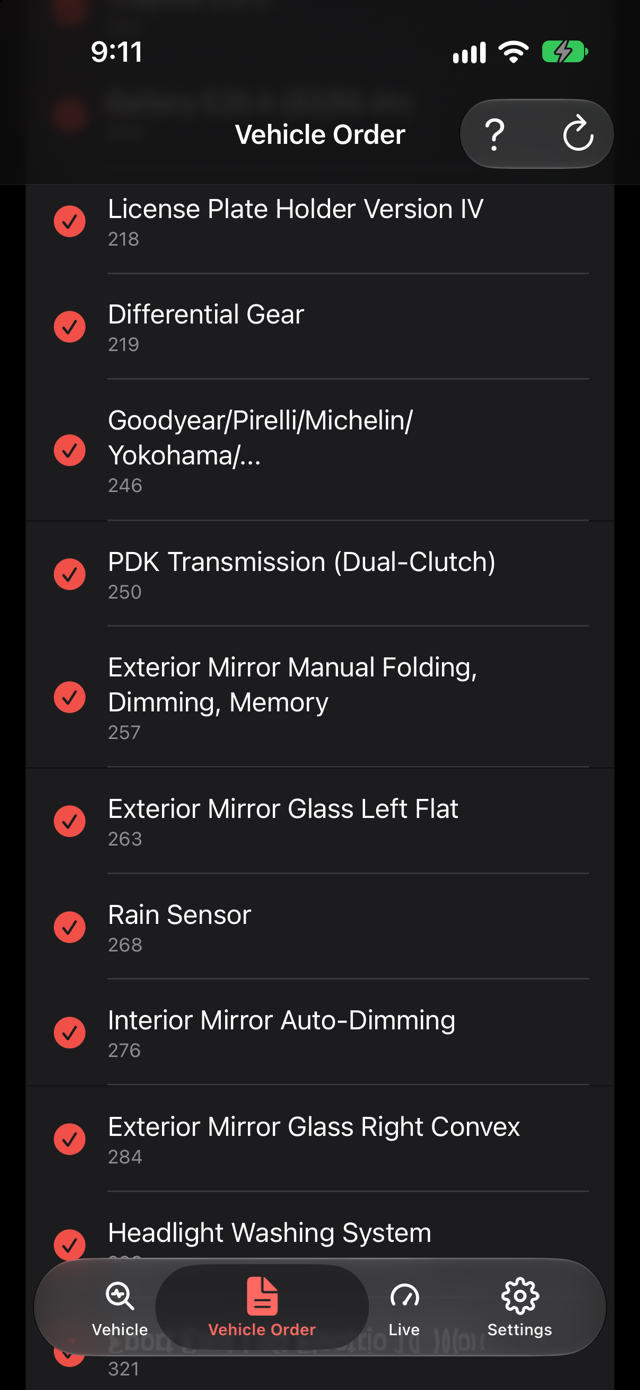 The car's factory build sheet, listing option codes by name: PDK transmission, rain sensor, auto dimming interior mirror, headlight washing system.